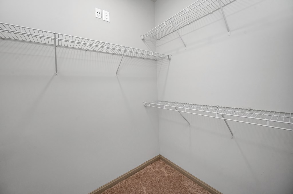 Empty room with white walls and shelving.
